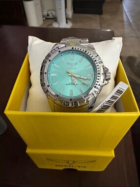 Invicta Silver Watch with Turquoise Dial and Yellow Accent